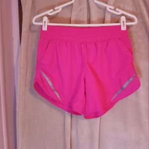 Bright pink work out shorts.